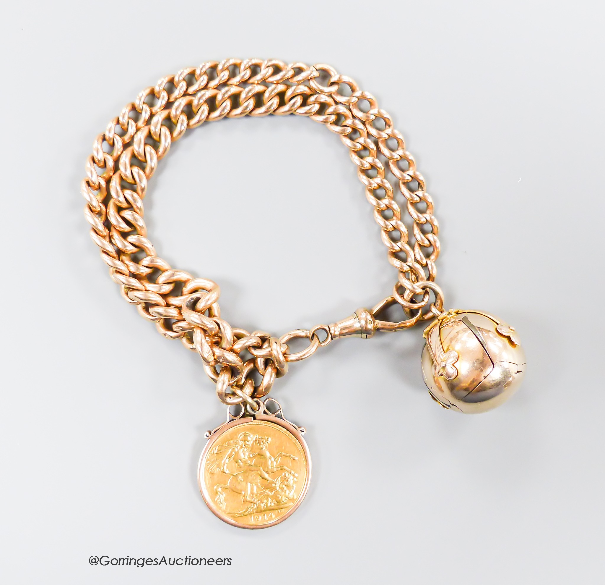 A 9ct gold graduated curb link, double strand bracelet, hung with a yellow metal mounted 1914 gold sovereign and a yellow and gilt white metal masonic ball, gross weight 61.8 grams.